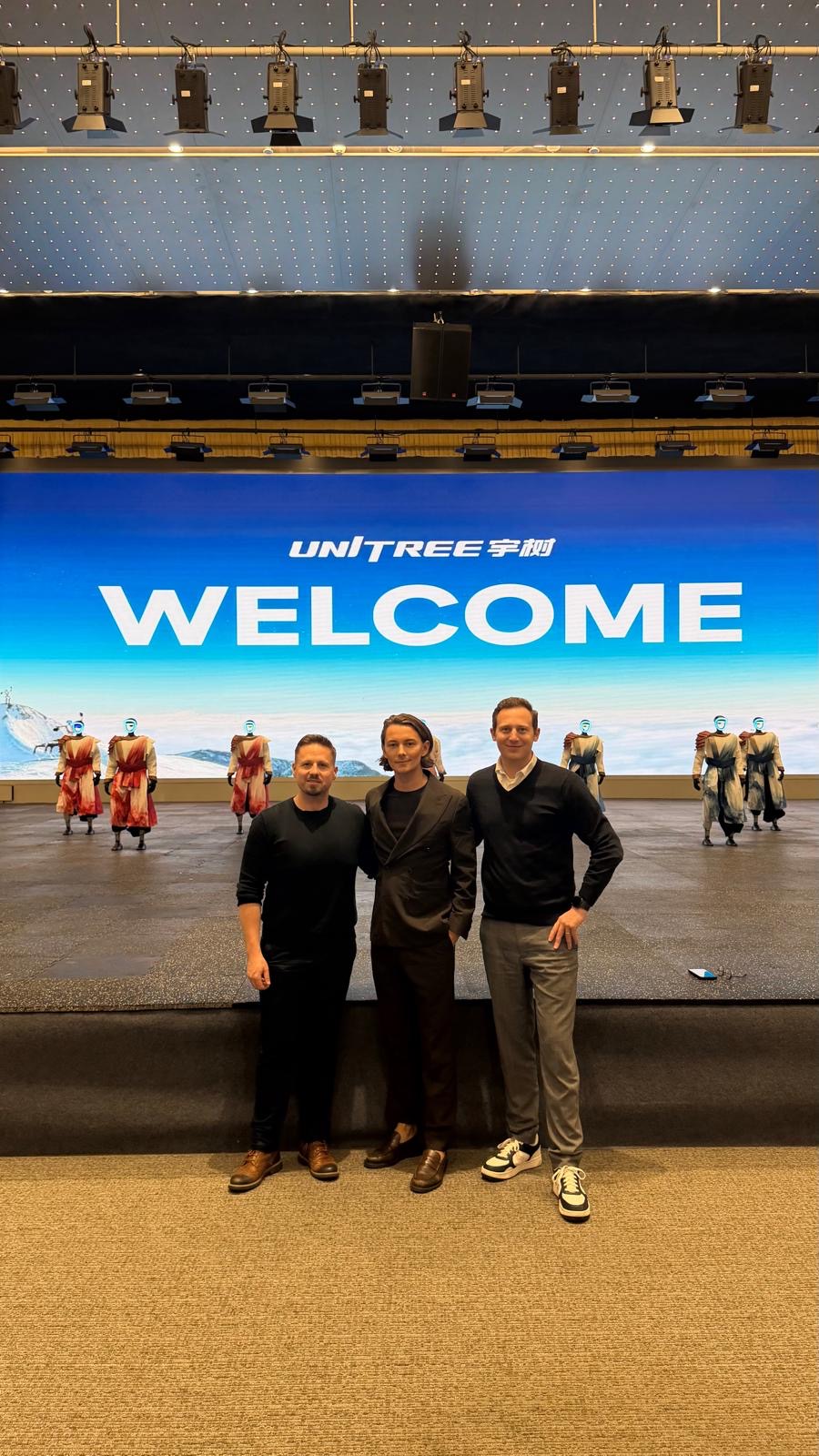 Visitors standing in front of humanoid robots at Unitree